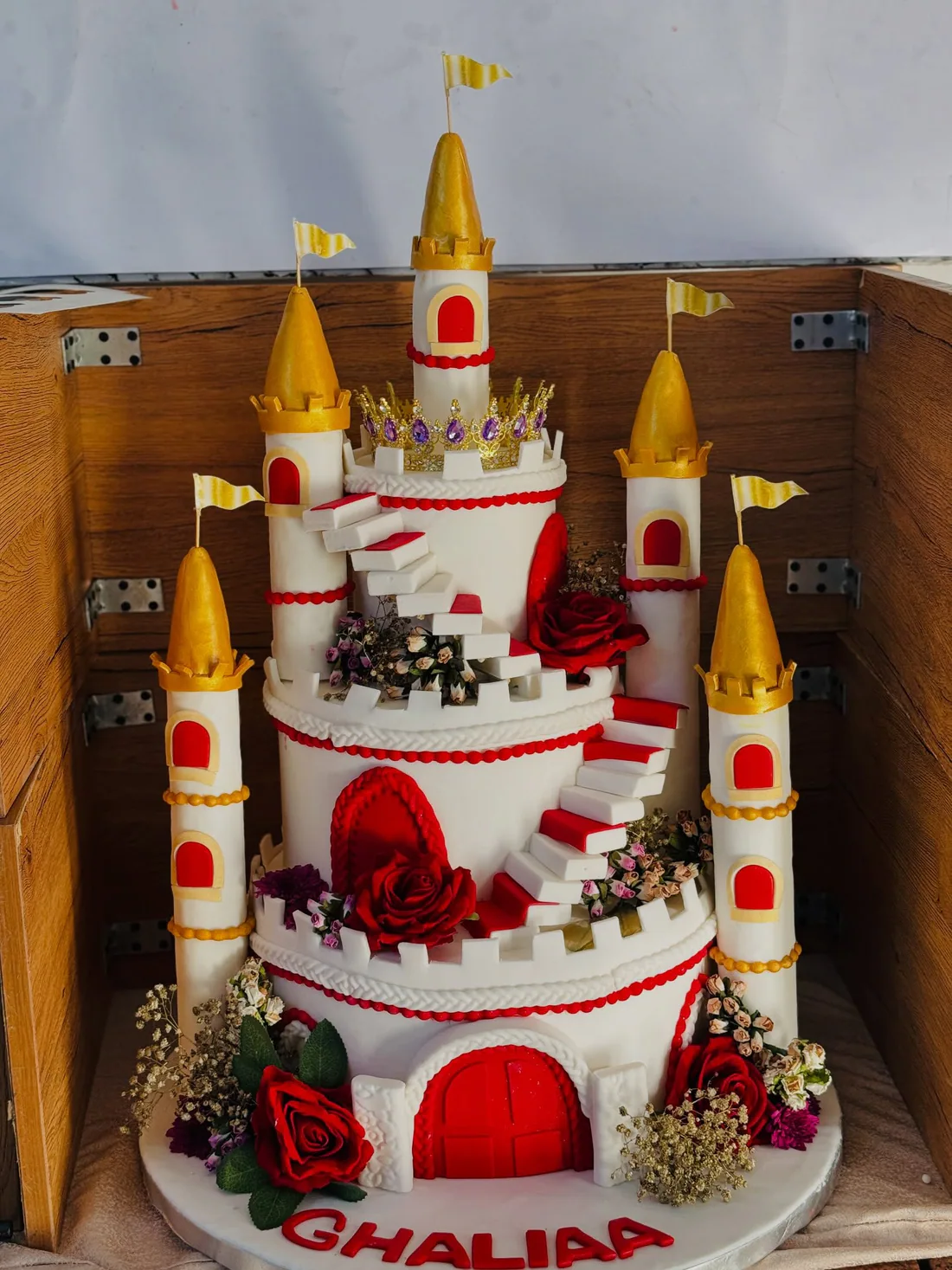 Large castle-shaped custom celebration cake with detailed sugar work